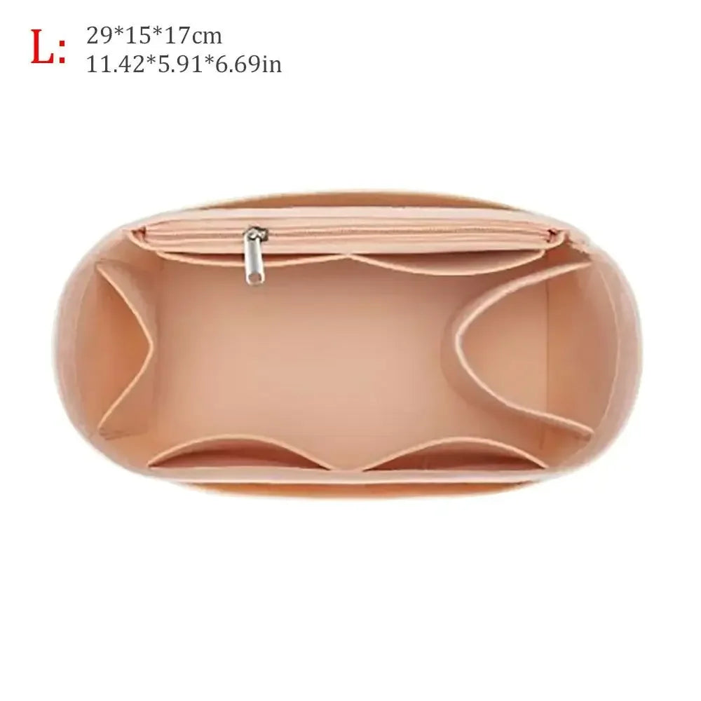 A light pink felt purse organizer insert showing the interior compartments and zipper.