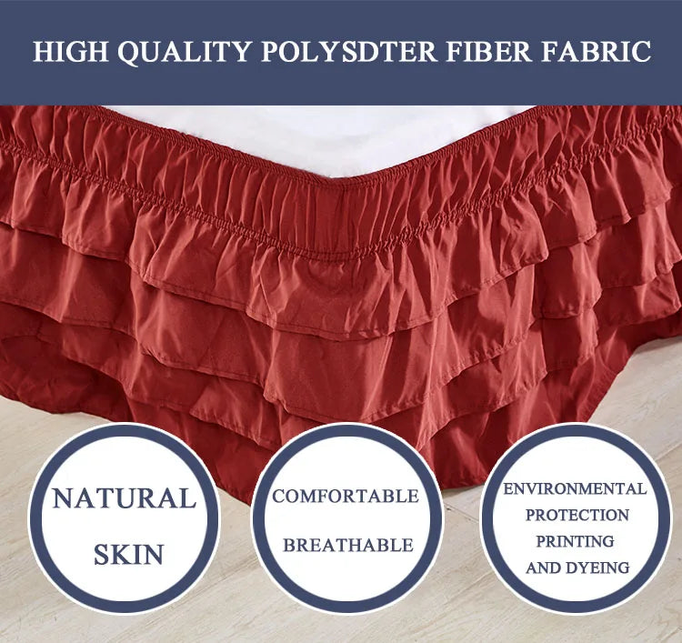 A close-up of a rust-colored polysdter fiber fabric ruffle skirt designed to wrap around a mattress.