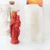 A reddish-pink silicone mold depicting a mother and child, used for religious candle and resin crafting.