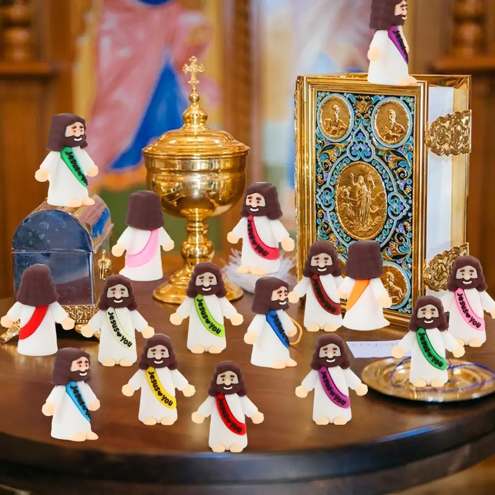A collection of mini Jesus figurines in various colors and outfits displayed on a wooden surface.