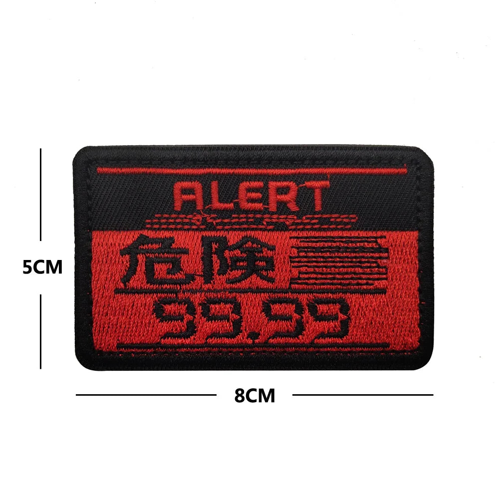 Black embroidered patch with red text ALERT and 99.99 featuring a foxhound design.