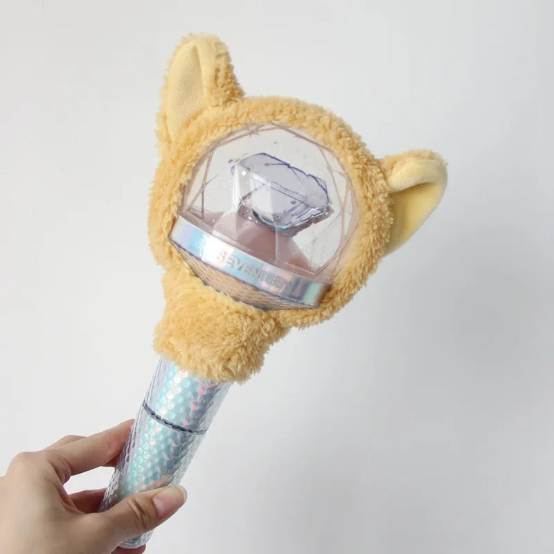 A plush cat-shaped cover for a SEVENTEEN official light stick is held in a hand.