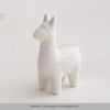 White ceramic figurine of a rabbit with textured body and long ears.