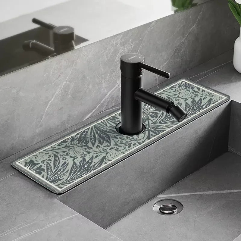 A modern black faucet mounted on a stone countertop with a decorative floral mat.