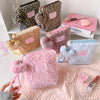 A collection of vintage leopard print cosmetic bags in various shades and textures displayed on a white surface.