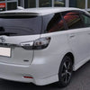 A white Toyota Prius minivan with dark window tint parked outdoors.