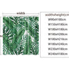 A pattern of green tropical leaves on a shower curtain.