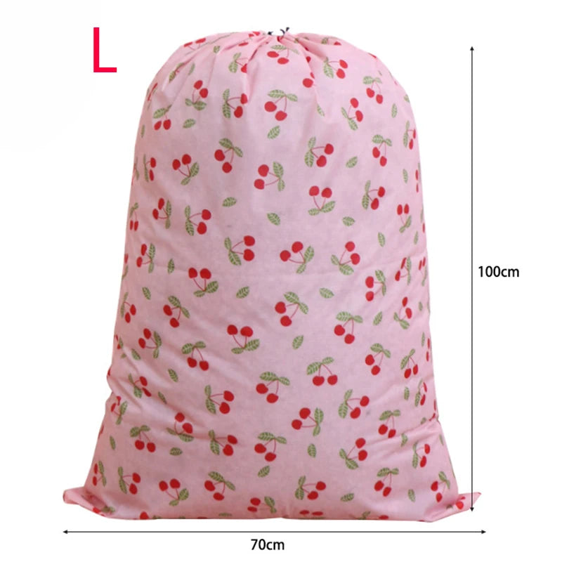 Pink drawstring laundry bag with a cherry pattern, shown from the front.