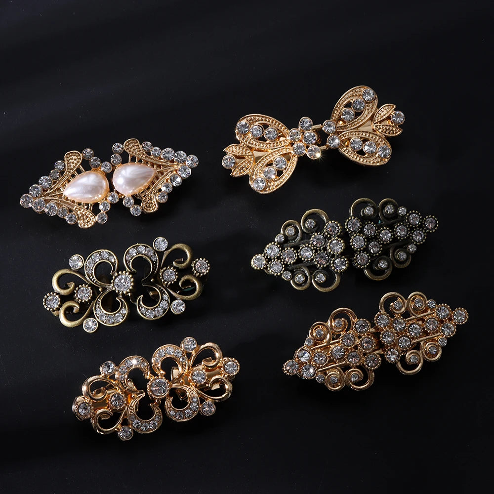 A collection of vintage gold and silver floral swirl clips for decorating cardigans and shawls