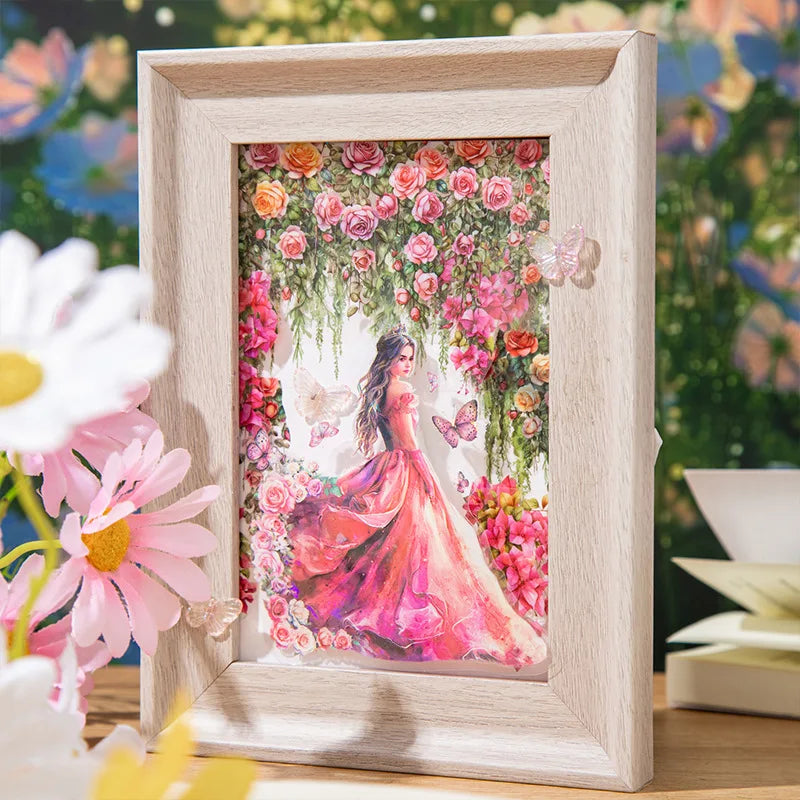 A framed watercolor illustration of a woman surrounded by pink and red roses and greenery.