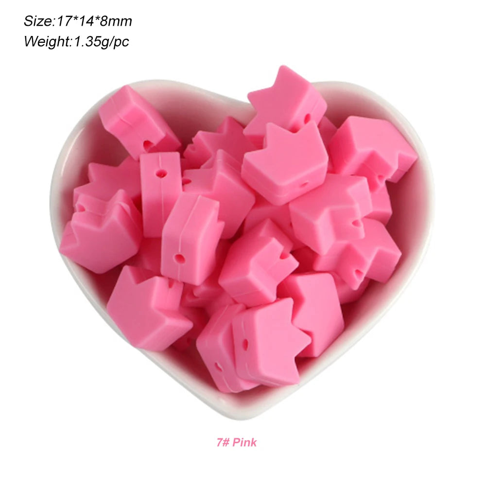 A pile of pink silicone crown star heart beads for DIY jewelry making