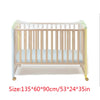 A wooden baby crib with a sheer mosquito net covering, featuring light wood and pale blue fabric.