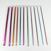 A set of 23 Tunisian crochet hooks with various colored bamboo cables arranged in a row.