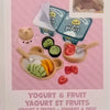 A DIY kit featuring a baby doll and miniature food accessories for yogurt and fruit