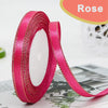 Roll of bright pink gold-edge satin ribbon for crafts and gift wrapping