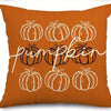 Orange pillow covers featuring white line drawings of pumpkins