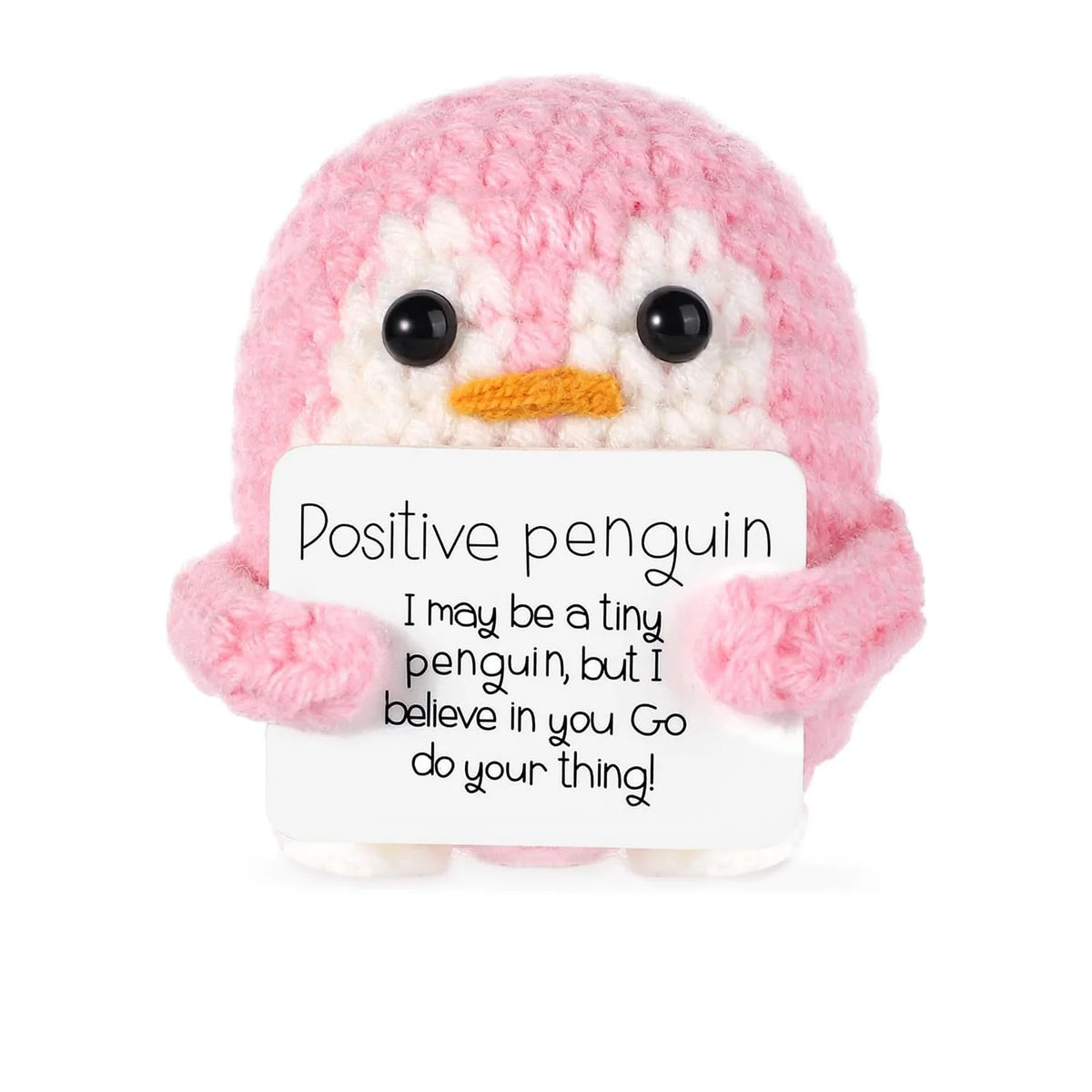 A handmade knitted pink penguin doll with a white card that reads Positive penguin I may be a tiny penguin but I believe in y
