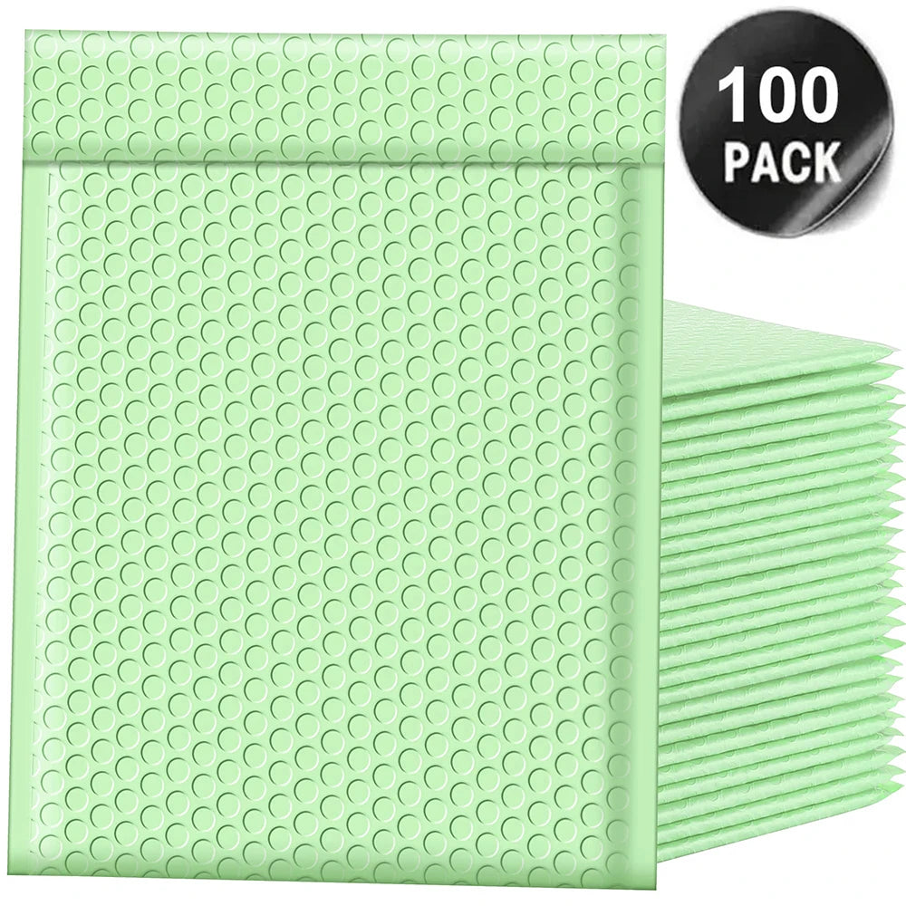 A stack of 100 green bubble mailers with a black label indicating the quantity.