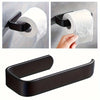 Black self-adhesive toilet paper holder with a white roll mounted on a wall.