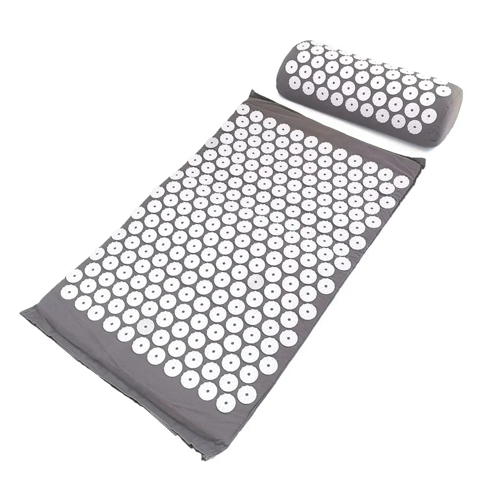 A gray acupressure mat and pillow set with numerous white acupressure points.