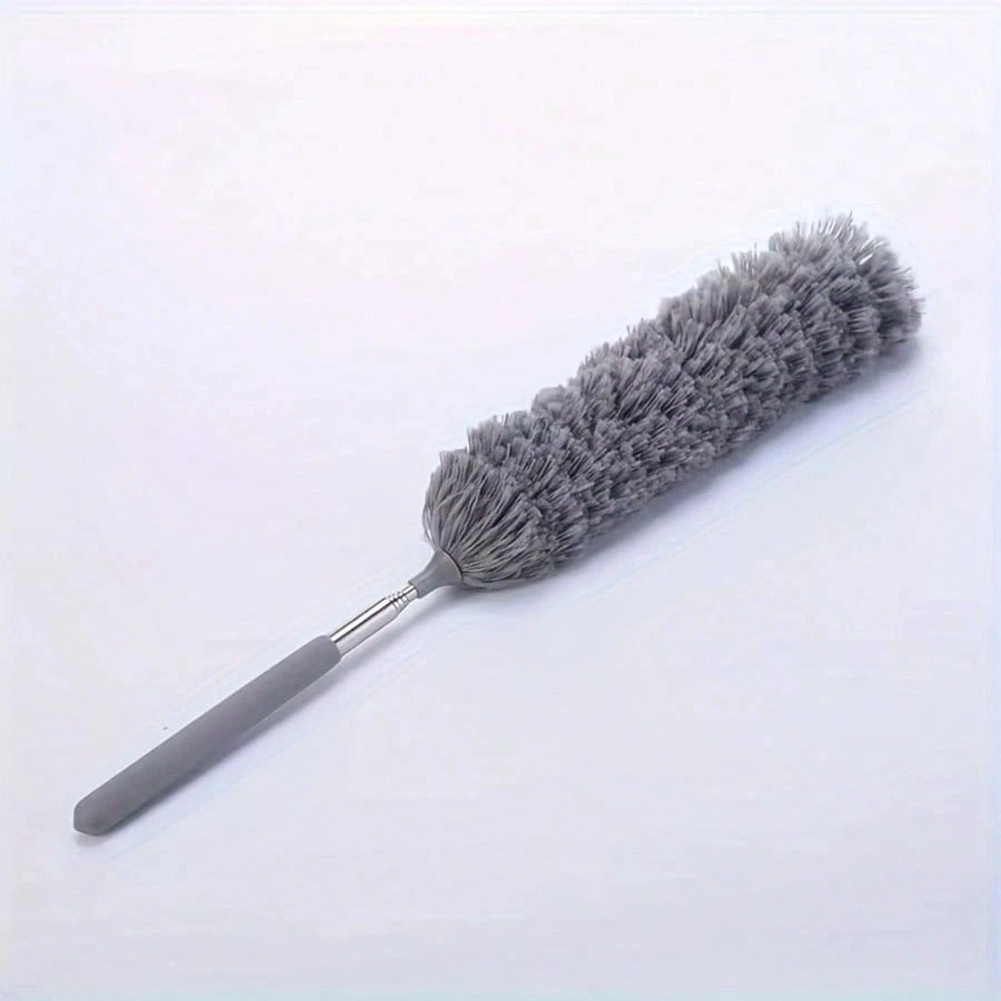 A gray flexible microfiber duster with a handle and dense bristles is shown against a white background.