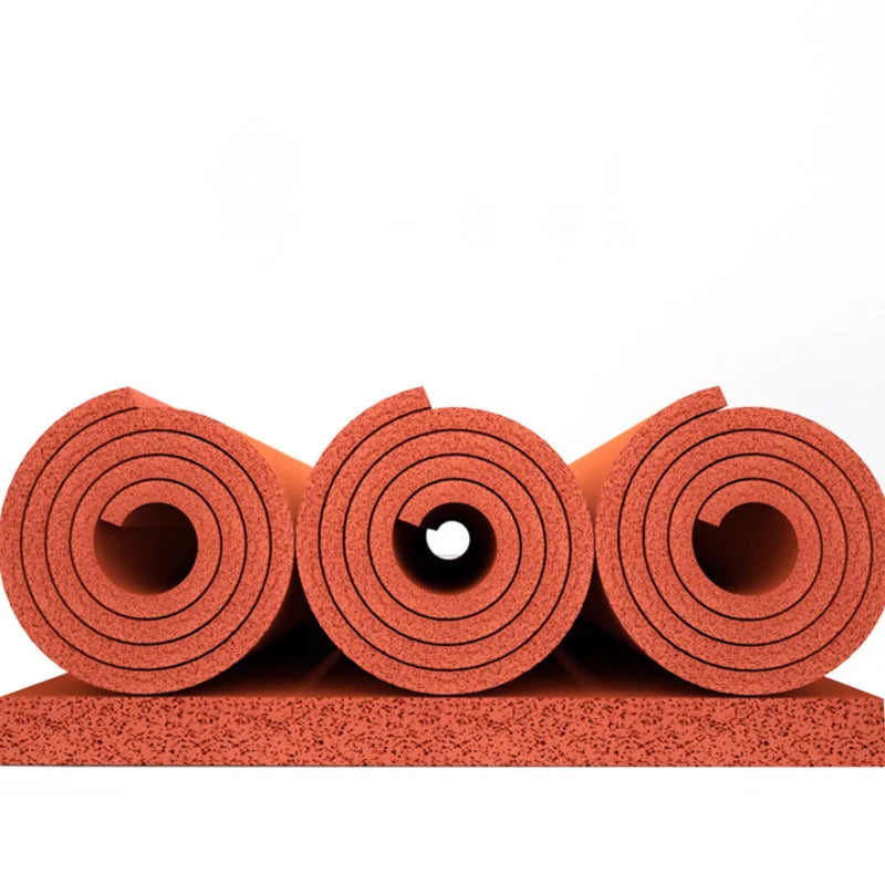 Rolls of red silicone heat-resistant craft mat material stacked on a surface