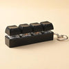 Black LED mechanical keychain fidget toy with custom keycaps displayed on a light background.