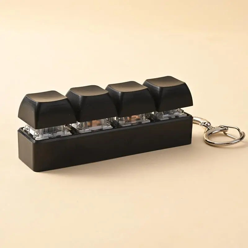 Black LED mechanical keychain fidget toy with custom keycaps displayed on a light background.