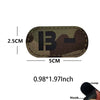 A dark camouflage blood type patch with the letter B and a dash, featuring a hook and loop backing.