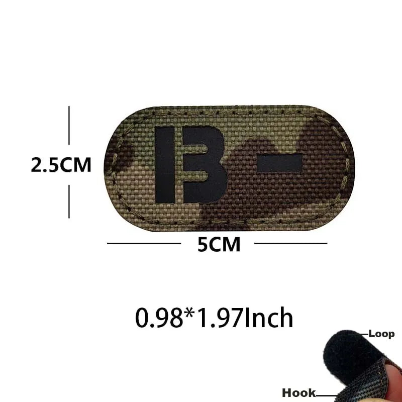 A dark camouflage blood type patch with the letter B and a dash, featuring a hook and loop backing.