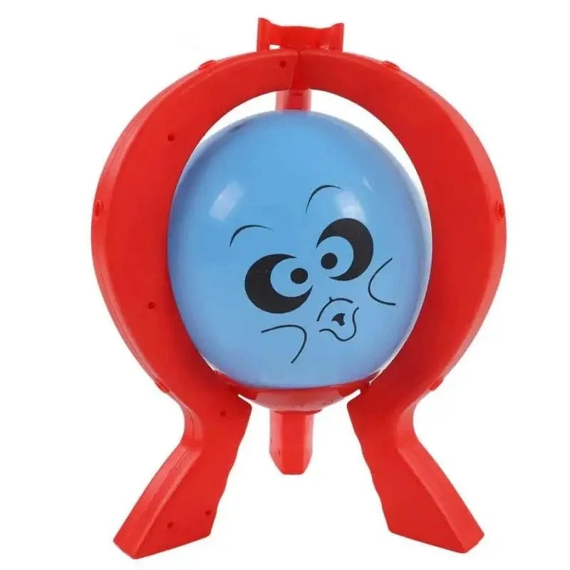 A red plastic game piece shaped like a balloon burst, used for a family strategy game.