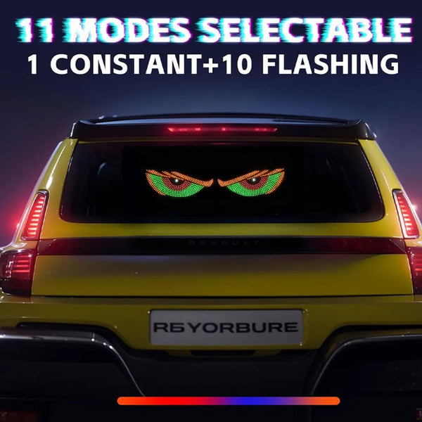 A yellow Renault vehicle features an LED light display with a demon eye design on the rear window.