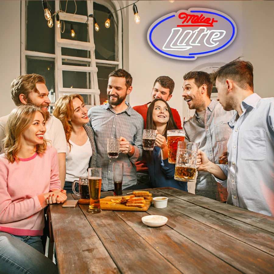 A group of friends enjoying drinks and conversation around a wooden table in a bar or social setting.
