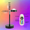 A sunset lamp projector with a stand and remote control demonstrating 180 degree light projection.