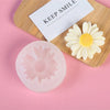 A silicone mold shaped like a daisy flower rests on a wooden board next to a card that says Keep Smile.