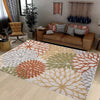 A rectangular outdoor area rug featuring a geometric pattern in shades of terracotta, olive green, beige, and gray.