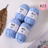 A stack of light blue Milk Cotton yarn skeins for knitting and crochet projects.