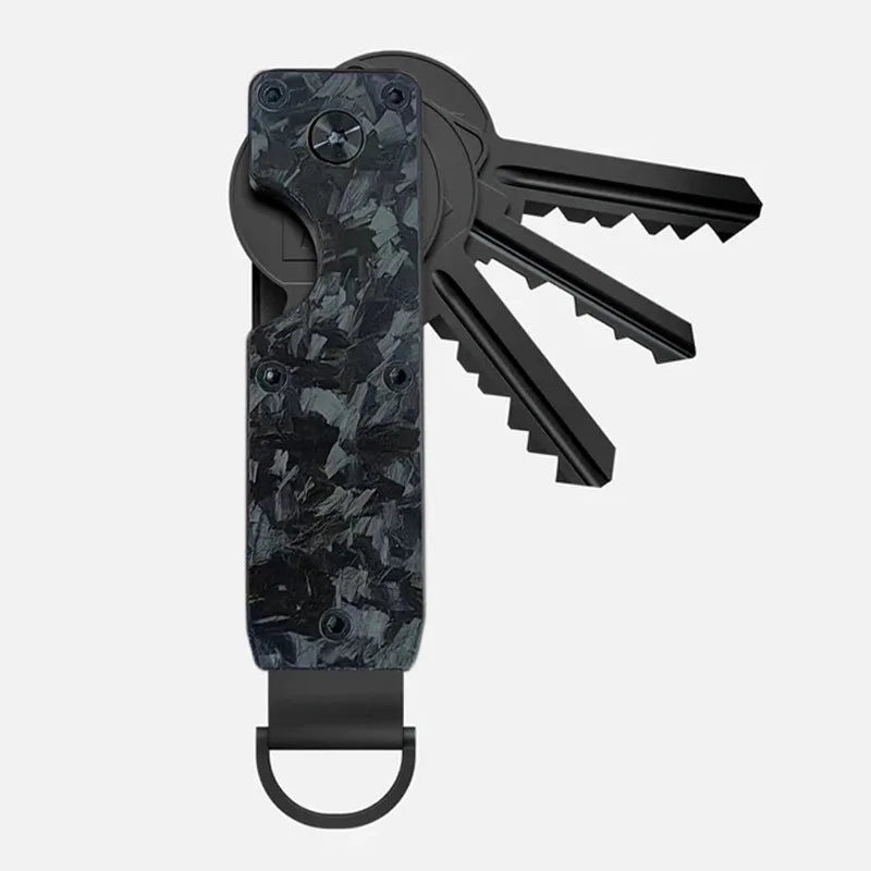 A black minimalist aluminum key organizer with a textured grip and a set of keys attached.