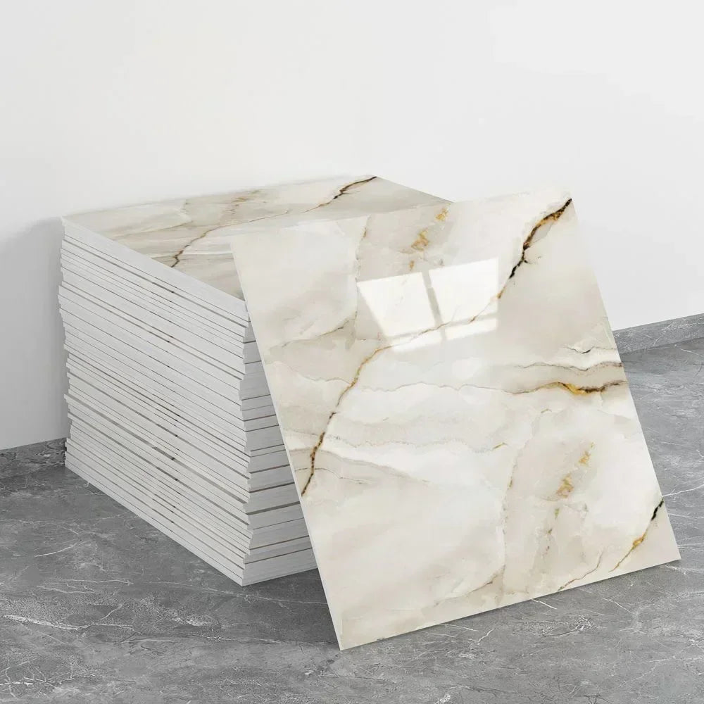 A rectangular panel of white marble effect wall sticker displayed next to a stack of white tiles.