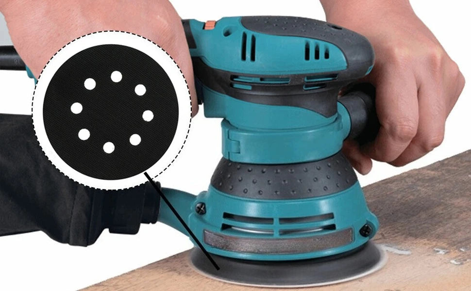 A hand is holding a teal foam sanding pad with visible holes, demonstrating the product for random orbit sanders.