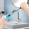 A hand is using a long, flexible bottle cleaning brush with a blue bristles to clean a kitchen faucet.