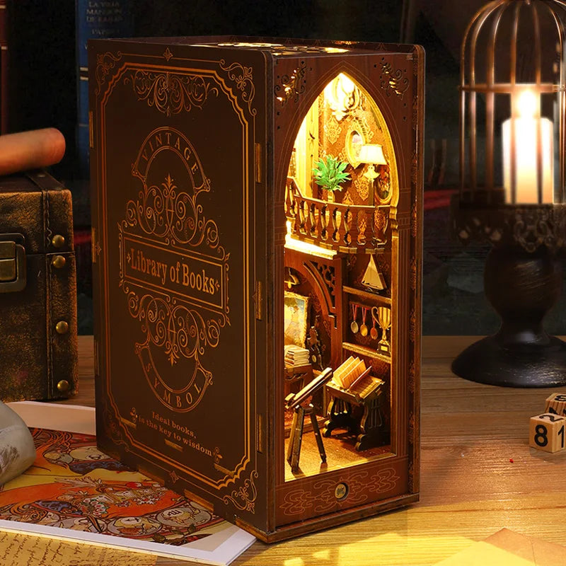 A wooden book nook kit with arched window display and internal LED lighting on a wooden surface.