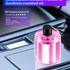 Bouteille d'huile essentielle de Gardenia rose dans un emplacement pour accessoires de voiture.