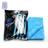 A black package of blue microfiber cleaning cloths with a light blue towel visible beside it.