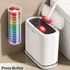 A white wall-mounted toilet brush holder is shown next to a colorful cylindrical brush with disposable heads.