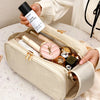 A beige cosmetic bag is shown open, filled with various beauty products and a black bottle of Super Snow Pine perfume.