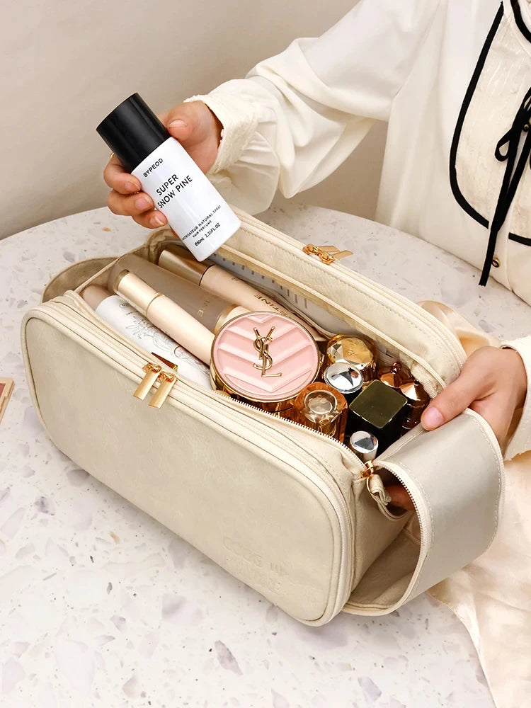 A beige cosmetic bag is shown open, filled with various beauty products and a black bottle of Super Snow Pine perfume.
