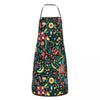 A black apron with a vibrant Mexican floral pattern featuring yellow, orange, and green flowers and leaves.