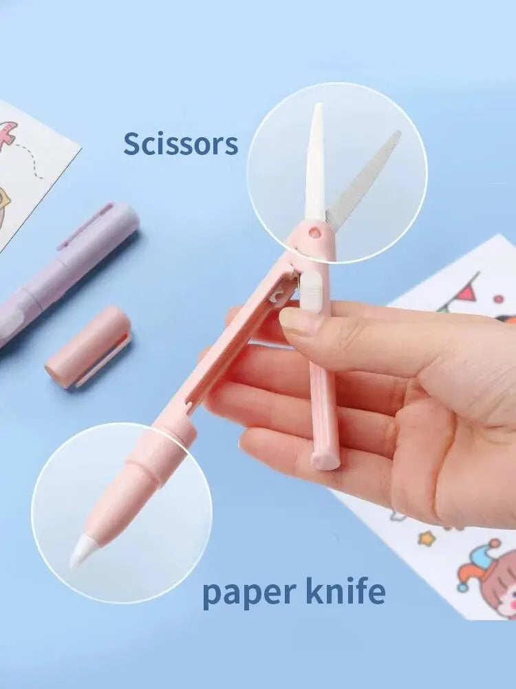 A hand holds a pink mini pen-shaped scissor and paper knife tool on a light blue background.