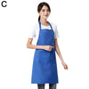 A woman wearing a royal blue waterproof apron with a front pocket over a white shirt.